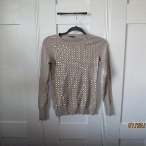 Tan sweater with gold details on the front